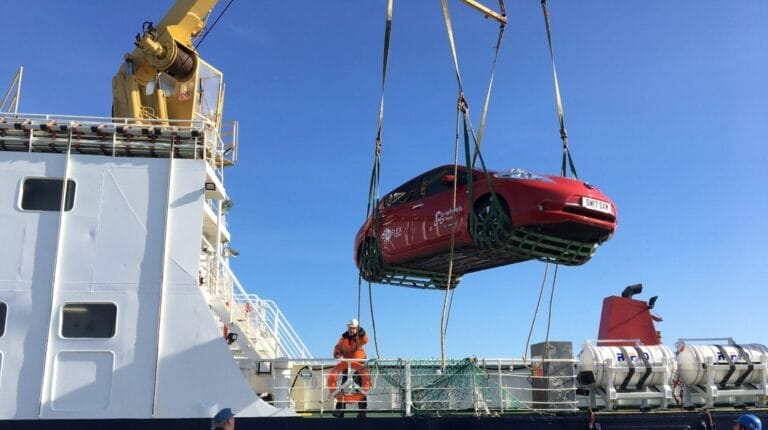 Reflex Car club car being hoisted off ferry in North Ronaldsay, Orkney