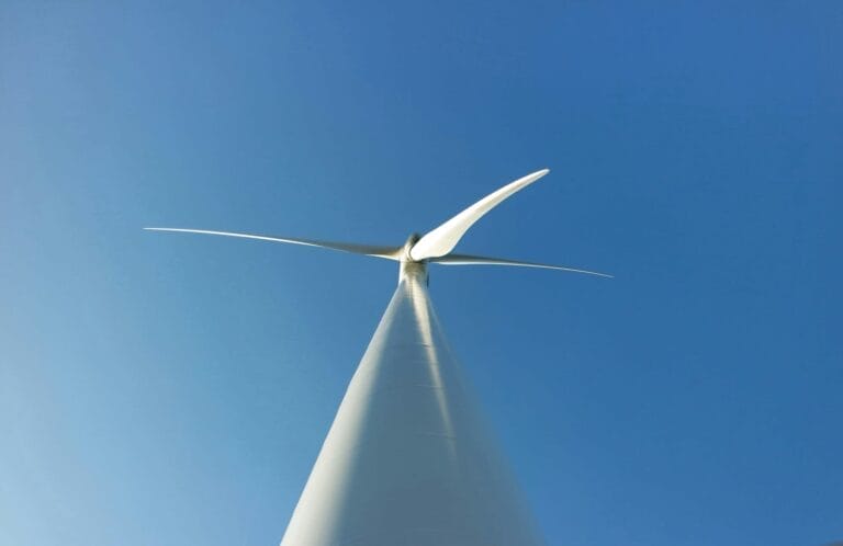 Wind turbine in blue sky - angle from ground