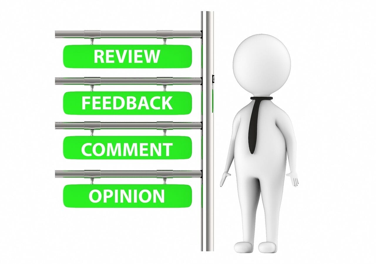Stylised model of human standing next to signpost saying review, feedback, comment, opinion.